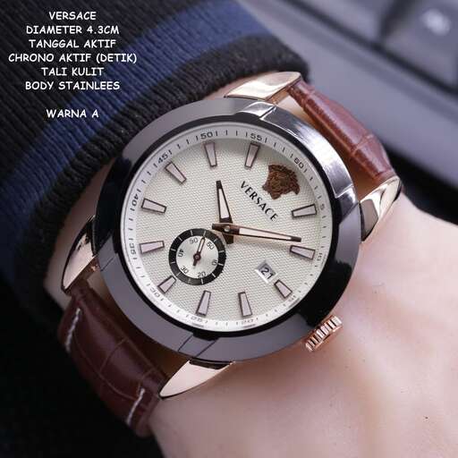 a watch with a brown leather strap on a person's wrist.