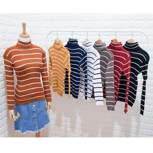 a rack of sweaters hanging on a wall