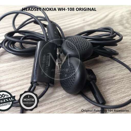 a pair of black headphones sitting on top of a wooden table.