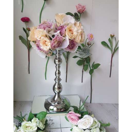 a vase with flowers on a table with a vase of flowers.
