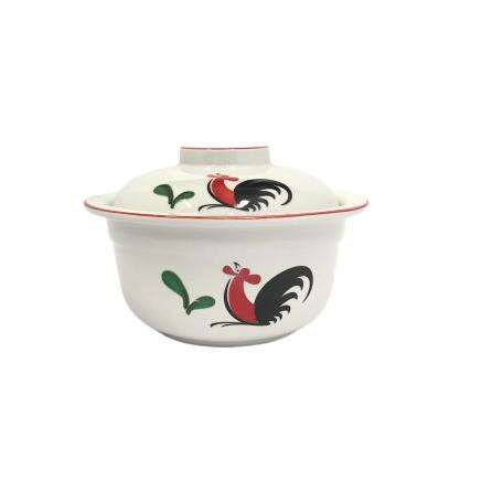 a chinese style bowl with a rooster on the front.