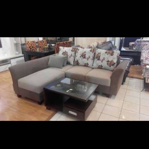 a living room with a couch, coffee table and coffee table.