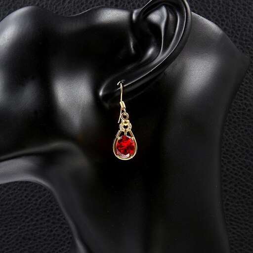 a necklace with a red stone pendant.