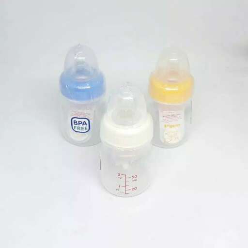 a group of baby bottles sitting on top of a white surface.
