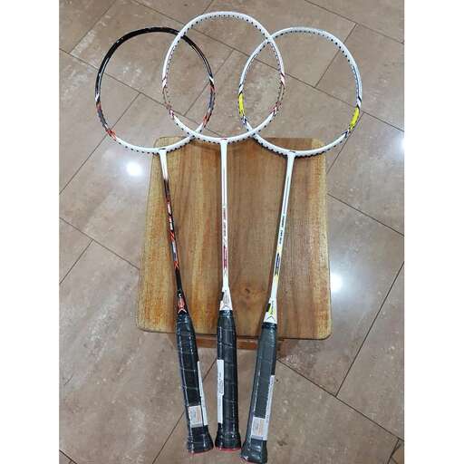 a pair of tennis rackets on a wooden board.