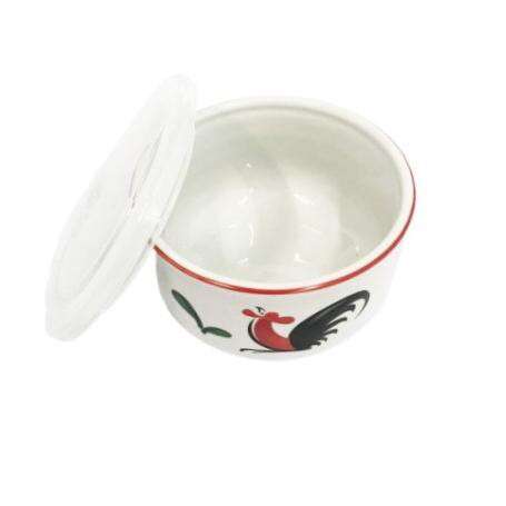 a bowl with a bird on it is sitting on a white background.