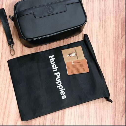 a black bag with a black strap and a pen on it.