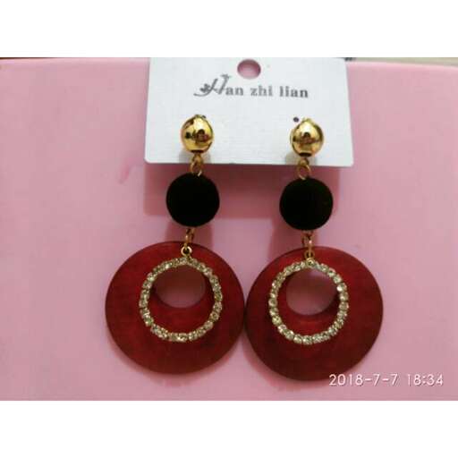 earrings with a gold chain and a red and black diamond.