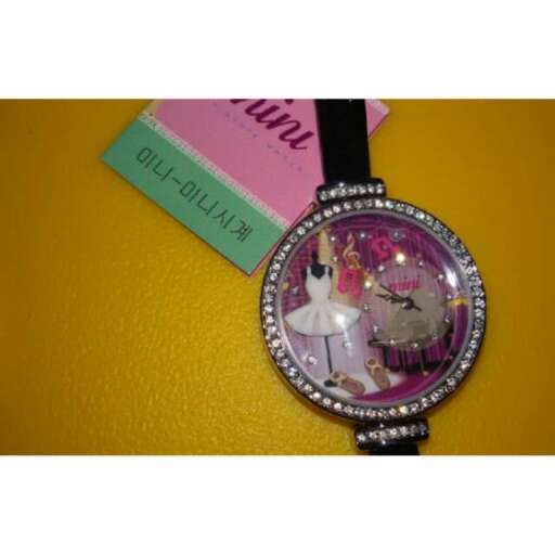 a watch with a photo of a woman's face and a flower in the center.