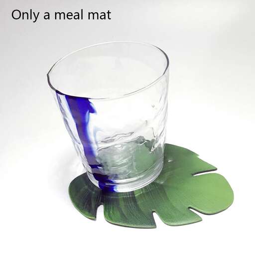 a glass of water with a leaf in it.