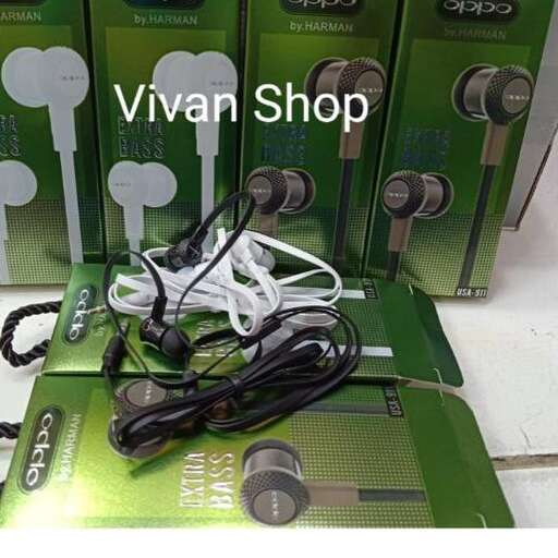 a bunch of headphones that are on a green mat.