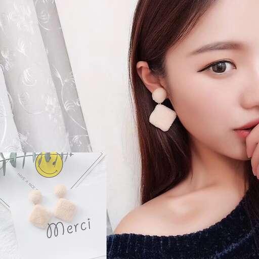 a girl with earrings and a smile