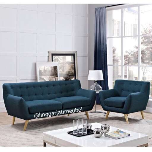 a living room with a blue couch and a white table