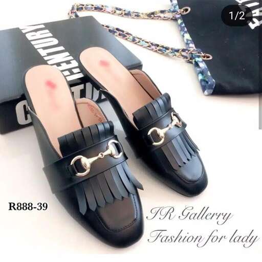 a pair of black leather sandals with a gold chain.