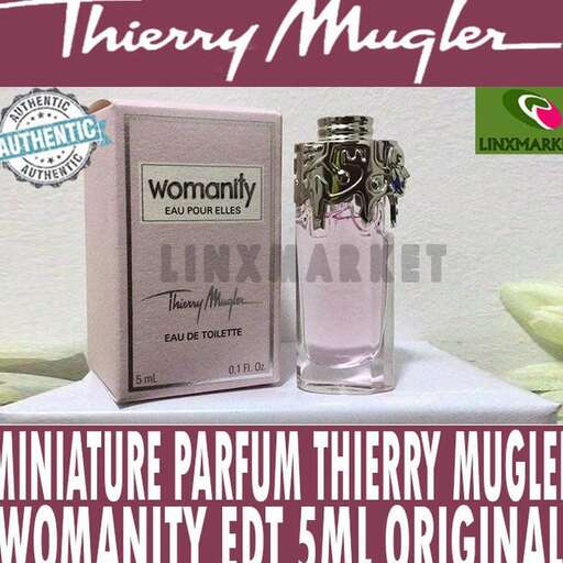 a bottle of perfume sitting on a table.
