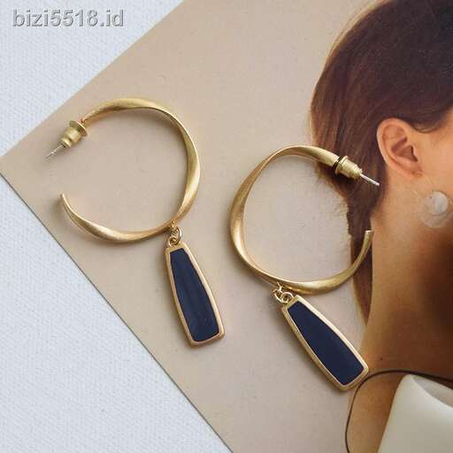 a pair of gold hoop earrings with a pair of earrings.