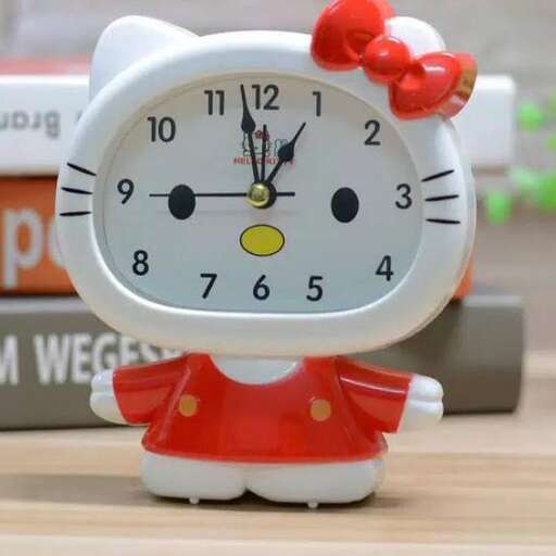 a clock with a red bow is sitting on a table.