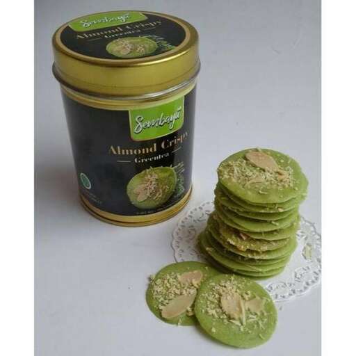 a jar of green cookies with a white doily.
