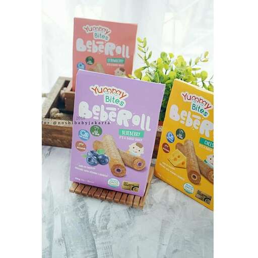 a set of three colorful boxes with candy on them.