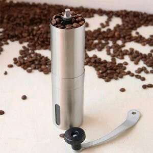 a metal container with coffee beans and a spoon.