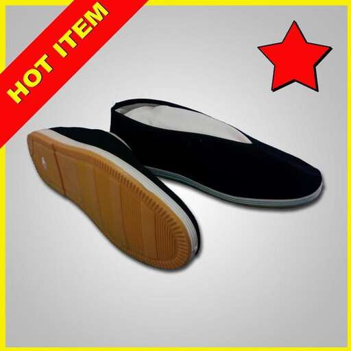 a black flat shoe with a red star on the back.