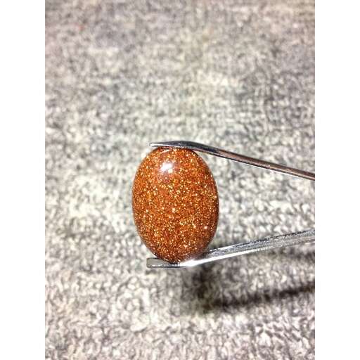 a fork with a piece of orange candy corn on it.