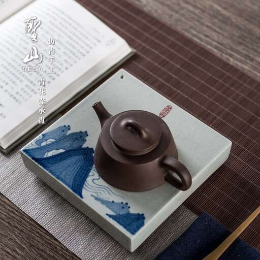 a teapot and a book on a wooden table