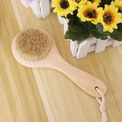 a wooden spoon with flowers in it on a wooden table.