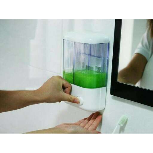 a person is putting a green liquid into a water dispenser.
