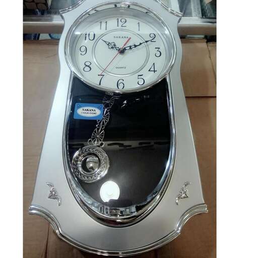 a clock with a white face and a silver chain.
