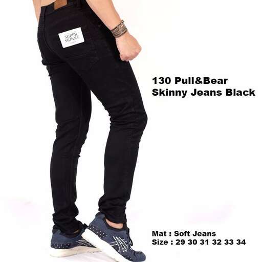 a pair of black jeans with a white tag on the front.