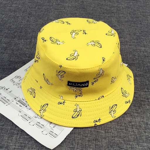 yellow hat with black and white print on the front.