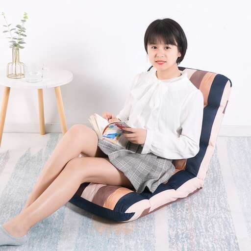 a woman sitting in a chair reading a book