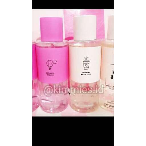 a bottle of perfume in pink