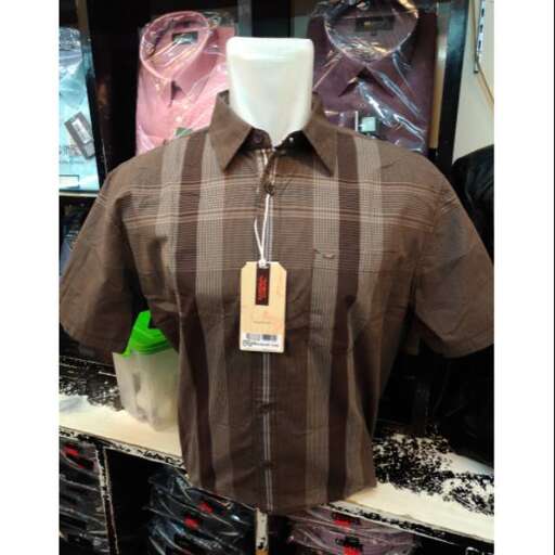 a brown and white shirt with a tag on the front.