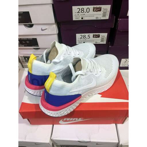 a pair of white and blue sneakers on a shoe box.