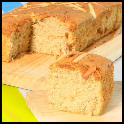 a piece of cake sitting on top of a wooden cutting board.