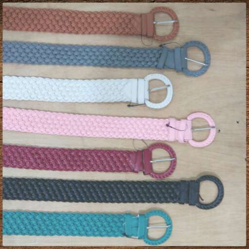 a bunch of different colored leashes on a table.