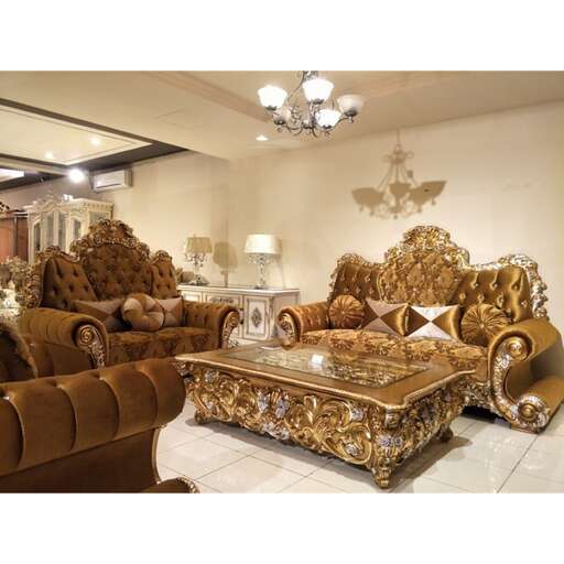 a gold and gold sofa and ottoman set in a large room.