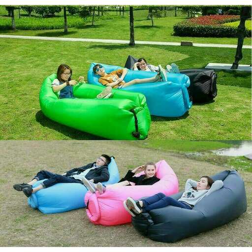 a group of people relaxing on a lawn in a park.
