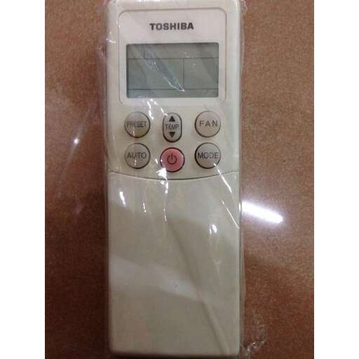 a white electronic device with a digital display on a counter.