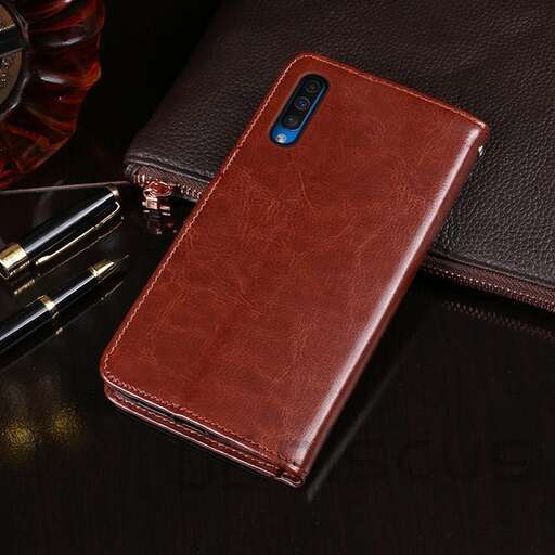a brown leather wallet sitting on top of a wooden table.