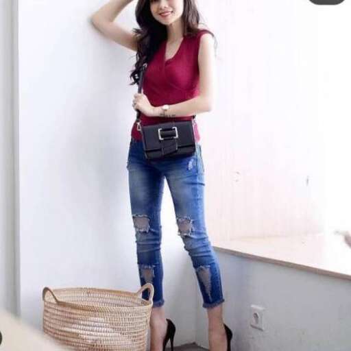 a girl in a red tank top and jeans.