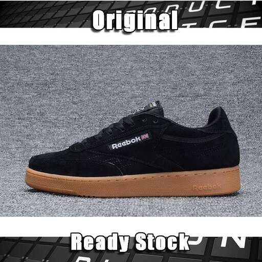 a pair of black canvas shoes with a black sole.