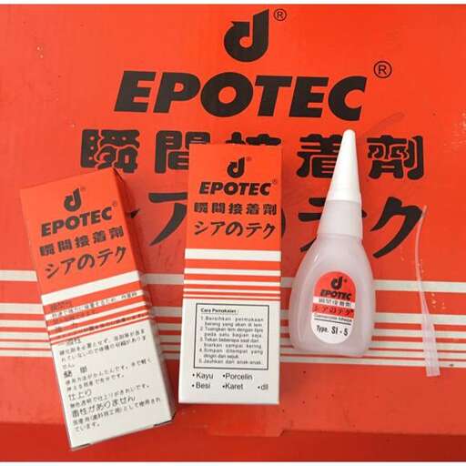 a sign with a bottle and some orange labels