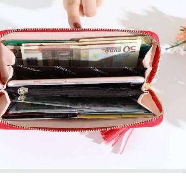 a red and white purse with a bunch of papers in it