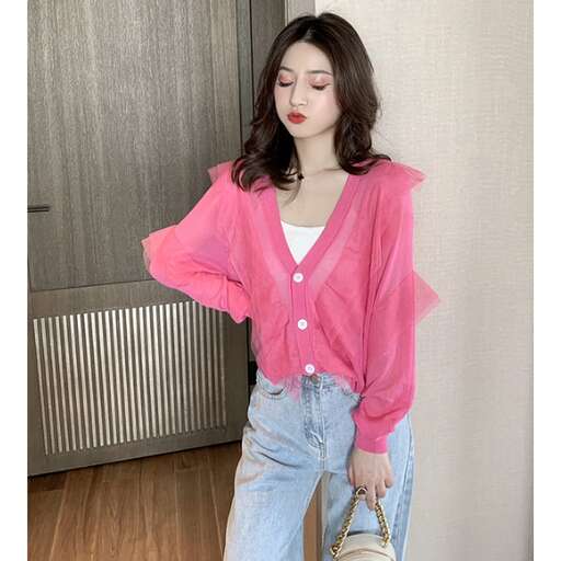 a woman in a pink shirt and jeans holding a purse.