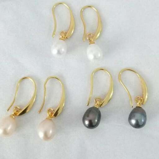 a pair of gold earrings with pearls and pearls