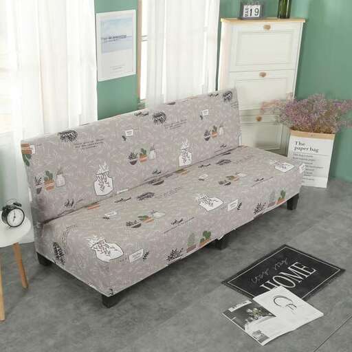a couch with a cover on it in a room.