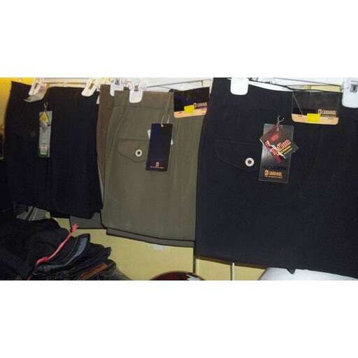 a variety of t - shirts in a store.